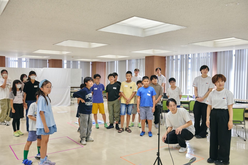 スクリーンの前に集まり、東京とあいさつを交わす