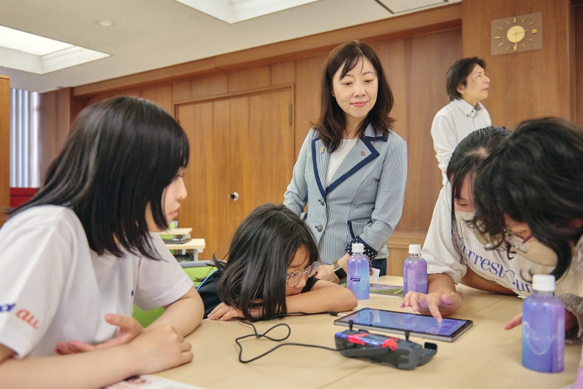 テーブルを回り、子どもたちの手元をのぞき込む瀧澤市長